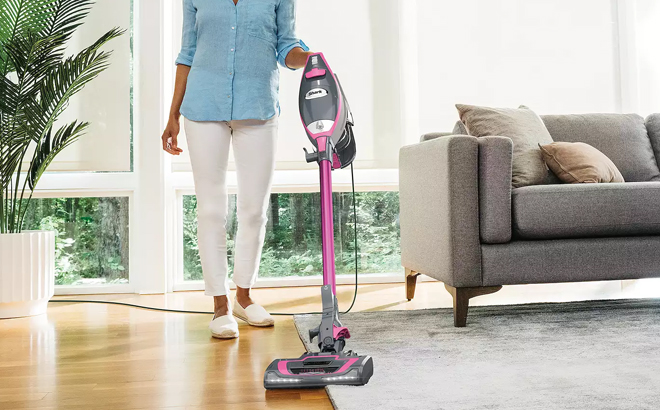 A Person Using a Shark Rocket Pro DLX Corded Stick Vacuum