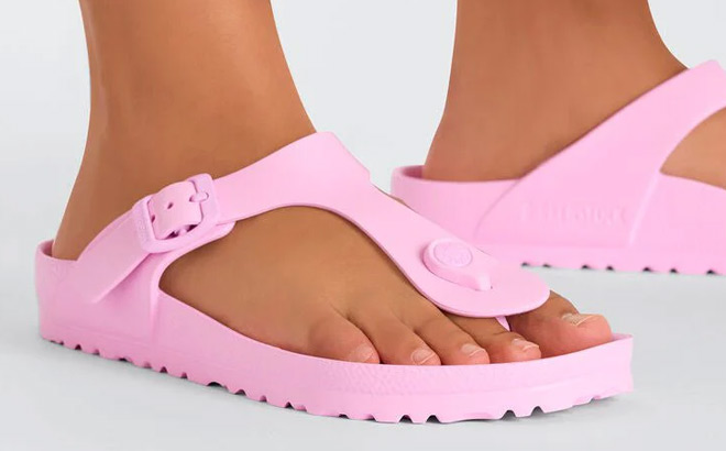A Person Wearing Birkenstock Womens Gizeh EVA Sandals in Pink Color