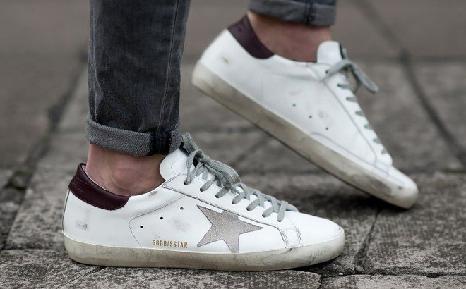 A Person Wearing Golden Goose Shoes