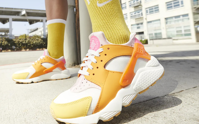 A Person Wearing Nike Air Huarache Womens Shoes