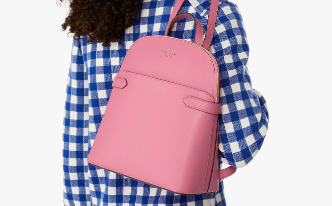 A Person Wearing the Kate Spade Staci Dome Backpack in Pink