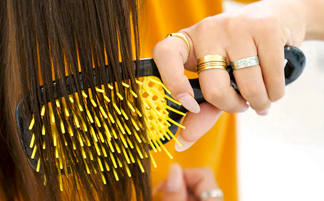 A Person brushing their Hair with UNbrush Detangling Hair Brush