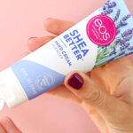 A Person holding Eos Shea Better Lavender Hand Cream