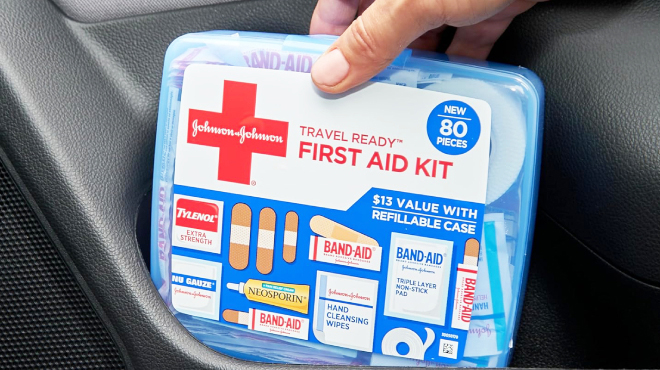 A Person holding Johnson Johnson Band Aid 80 Piece First Aid Kit