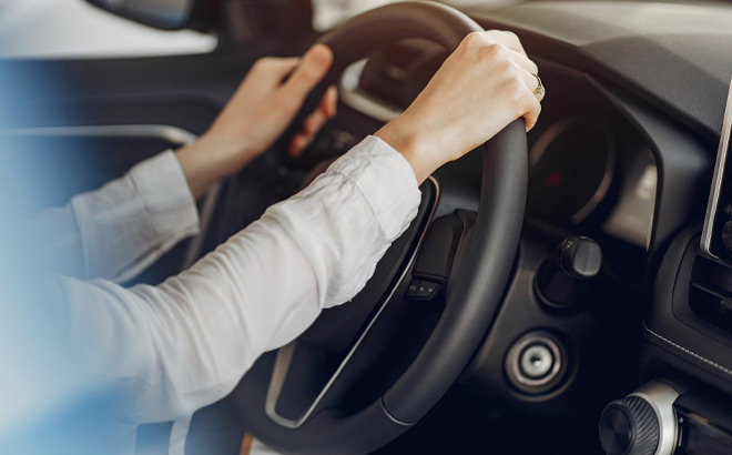 A Person is Holding Steering Wheel