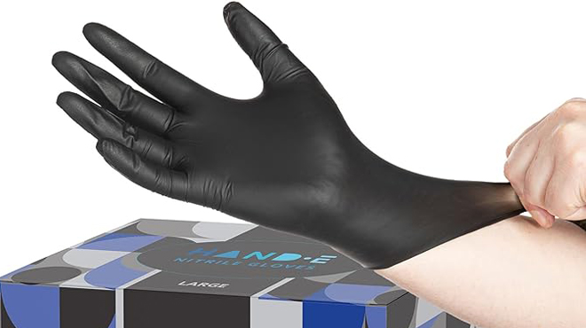 A Person putting on Hand E Touch Black Disposable Gloves
