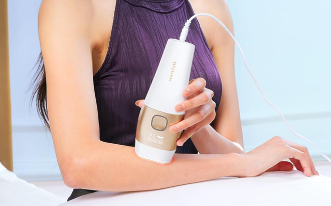 A Person using Wavytalk IPL Hair Removal Device on their arm