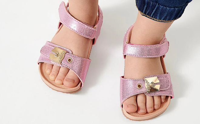 A Person wearing Dr Scholls Toddler Sandals in Hot Pink Color