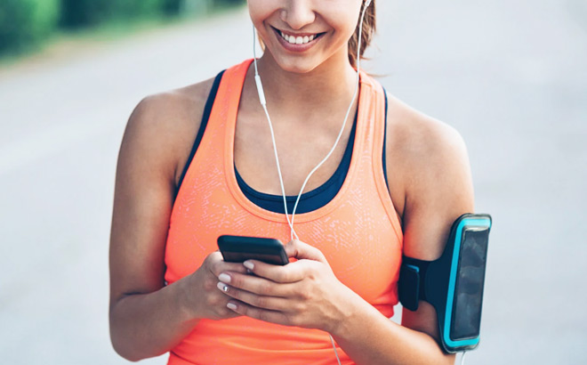 A Smiling Person in Activewear Looking at Mobile Phone