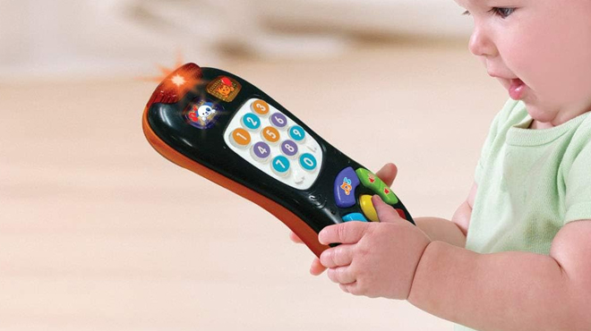 A Toddler Playing with VTech Click and Remote Toy