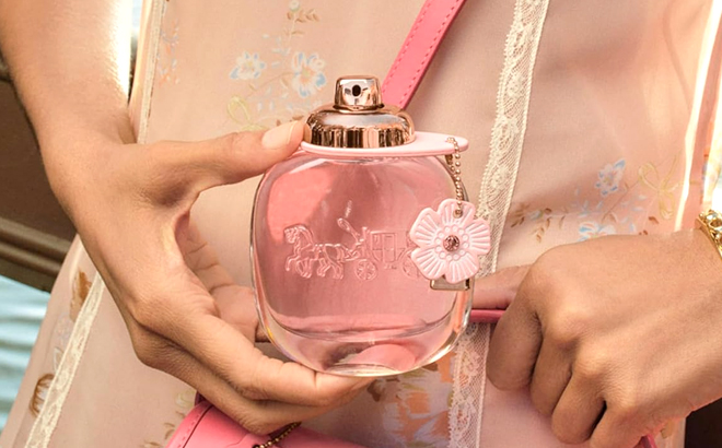 A Woman Holding Coach Floral Eau De Parfum