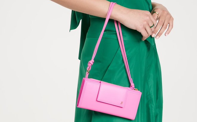 A Woman Holding Jacquemus Le Pichoto Wristlet