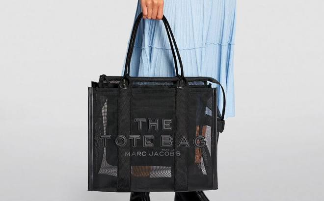 A Woman Holding Marc Jacobs The Mesh Large Tote