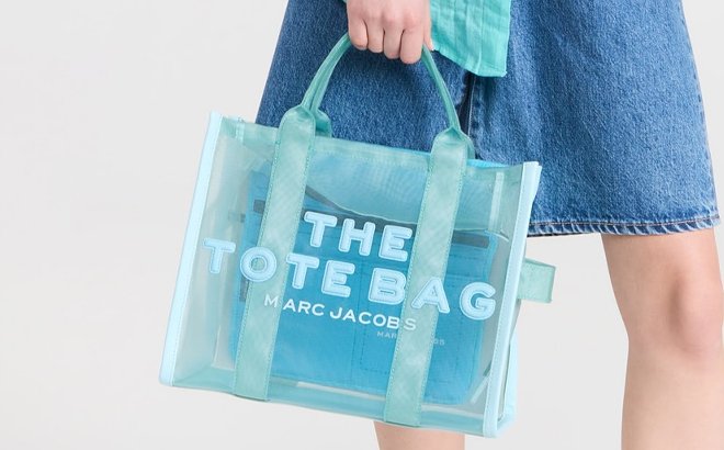 A Woman Holding Marc Jacobs The Mesh Medium Tote Bag in Pale Blue