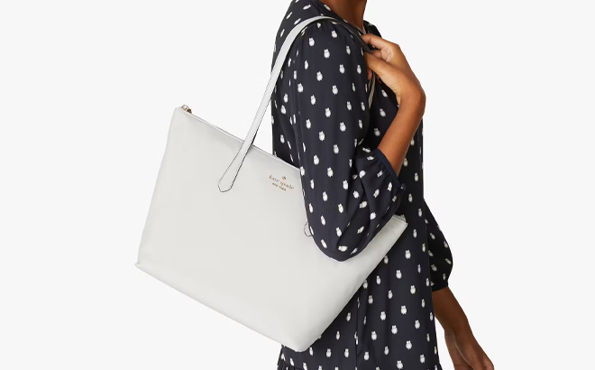 A Woman Wearing Kate Spade Kitt Nylon Large Tote in Platinum Gray