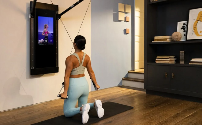 A Woman Working Out with Tonal Home Gym Machine