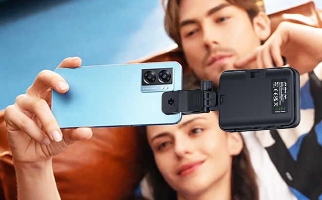 A couple taking a selfie using a Notixas Selfie Light