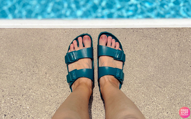 Woman Wearing Birkenstock Arizona EVA Sandals in Teal Color Next to a Pool