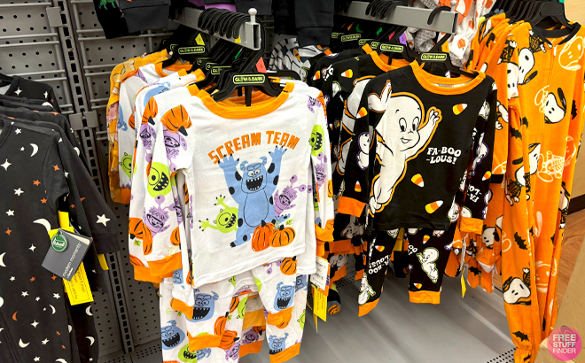 Glow in the Dark Halloween Pajama Sets on Hangers in a Store