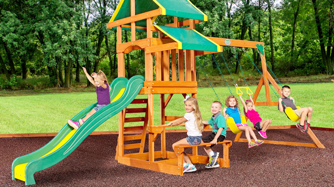 Kids Playing on a Backyard Discovery Wooden Swing Set 1