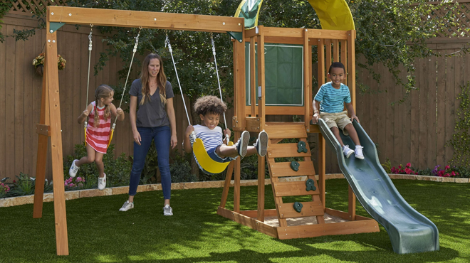 Kids Playing on a KidKraft Wooden Outdoor Swing Set