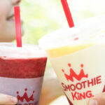 People holding Smoothie King Cups