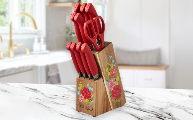 The Pioneer Woman Sweet Rose 11 Piece Stainless Steel Knife Block Set in Red Color on the Table