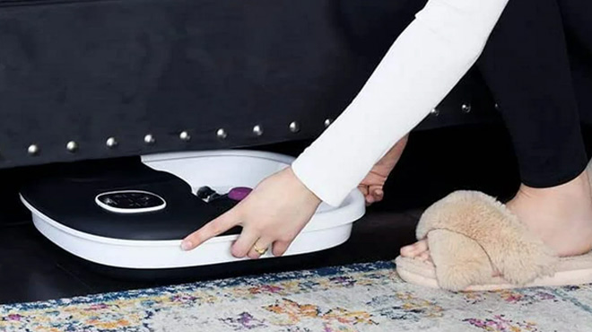 a Person Putting Foldable Foot Spa Massager under a Bed