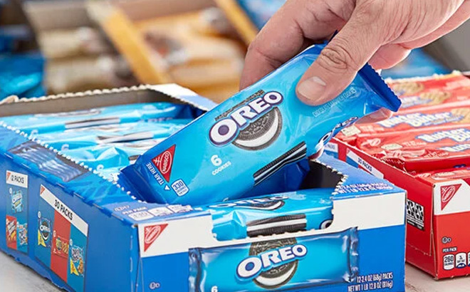a Person Taking a Oreo Sandwich Cookies Chocolate 6 Count Pack from a Box