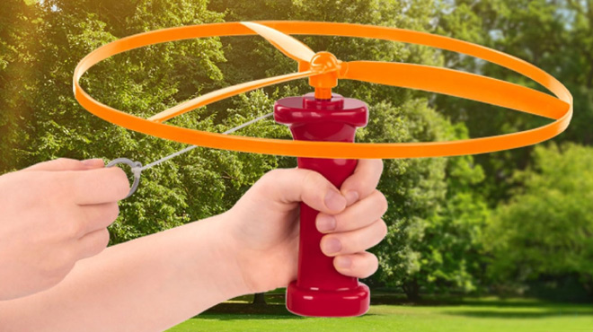 A Boy Playing with Battat Flying Disc Toy