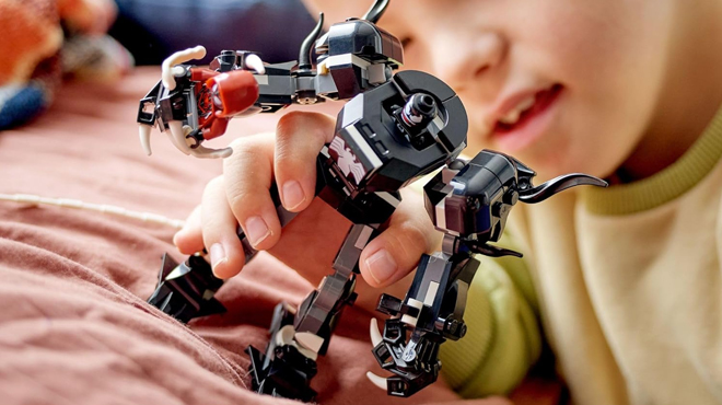 A Child Playing with The LEGO Marvel Venom vs Miles Morales Building Set