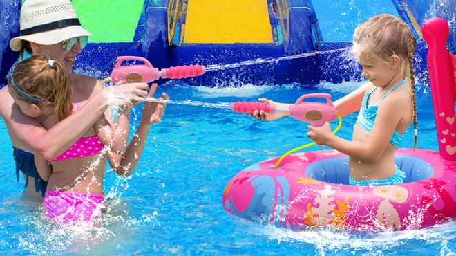 A Family Playing in a Pool Using a Pool Float with Water Gun