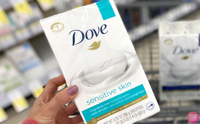 A Hand holding Dove Sensitive Skin 8 Count Bar Soap Pack