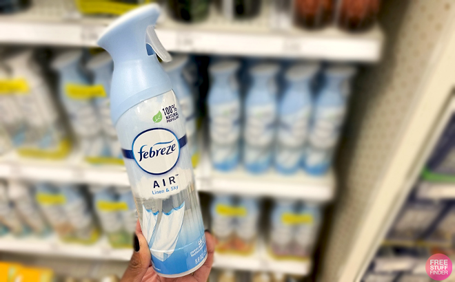 A Hand holding Febreze Linen and Sky Scent Air Freshener Spray