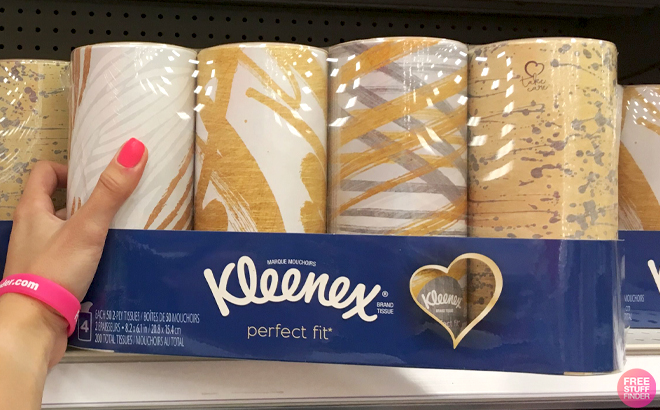 A Hand holding Kleenex Perfect Fit Tissues 4 Pack