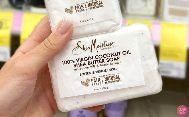 A Hand holding SheaMoisture 100 Virgin Coconut Oil Shea Butter Bar Soap