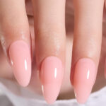 A Hand with Beetles Gel Almond Shaped Press On Nails in Neutral Pink Color