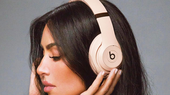 A Lady Listening to Music through Beats Studio Pro x Kim Kardashian Headphones