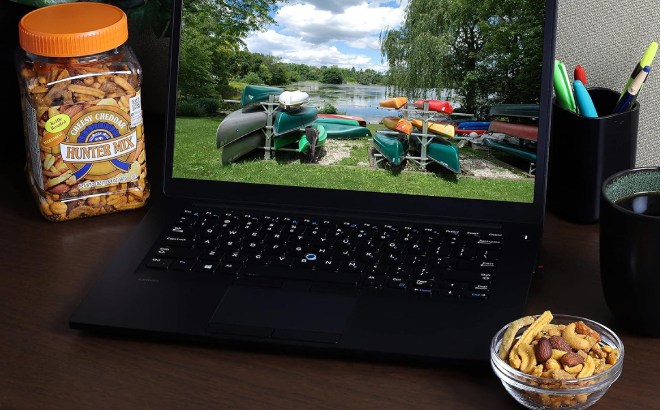 A Laptop with Southern Style Nuts Cheesy Cheddar Hunter Mix Snack at its Sides