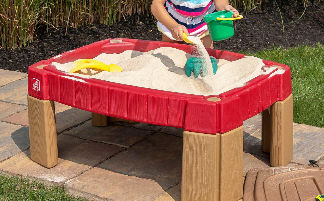 A Little Girl Playing with Sand Using Step2 Naturally Playful Sand Table