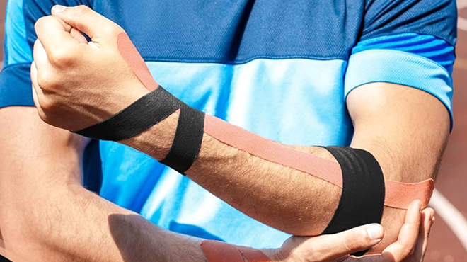 A Man Using Kinesiology Tape