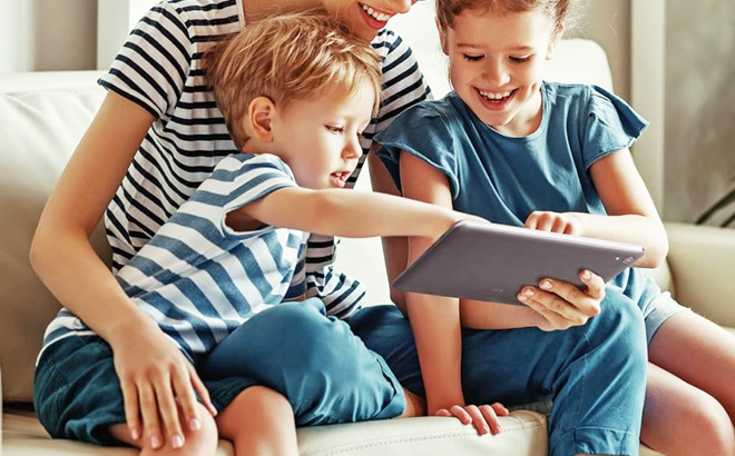 A Mother and 2 Children Using a Tablet