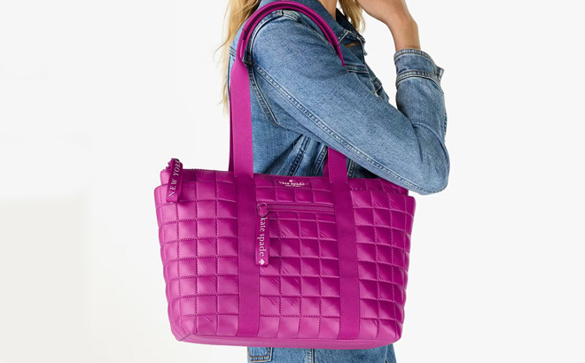 A Person Carrying a Kate Spade Camden Quilted Small Tote in Pink