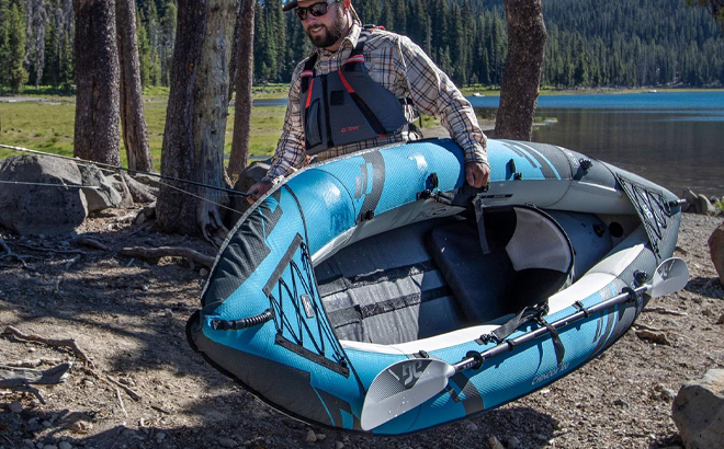 A Person Carrying the Aquaglide 2 Person Chinook Kayak