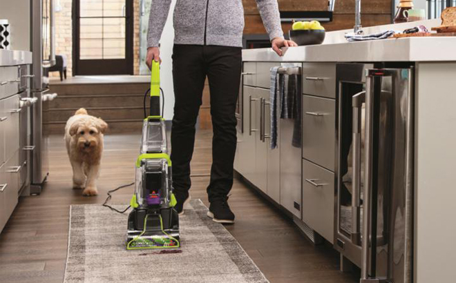 A Person Cleaning a Carpet with a Bissell Carpet Cleaner