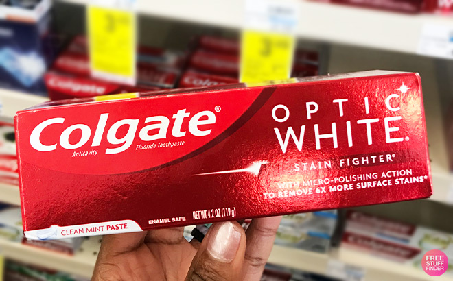 A Person Holding Colgate Toothpaste