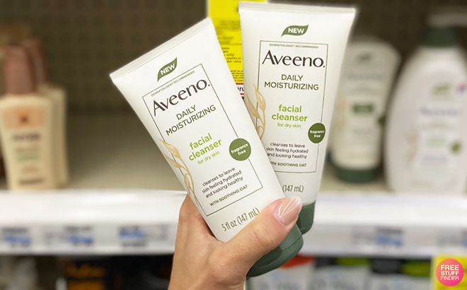 A Person Holding Two Aveeno Facial Cleansers at CVS