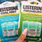 A Person Holding Two Packs of Listerine Cool Mint Pocketpaks 3 Count