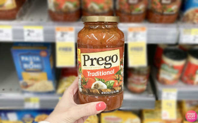 A Person Holding a Bottle of Prego Traditional Pasta Sauce