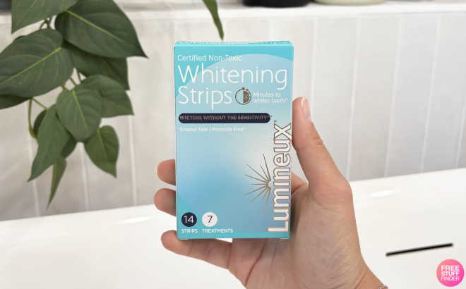 A Person Holding a Box of Lumineux Teeth Whitening Strips